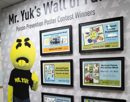 A wall inside the WAPC office with a life-sized Mr. Yuk and framed kids art