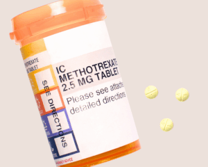 prescription bottle of Methotrexate and three pills